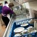 Volunteer Sharon Nakpairat organizes washed dishware at St. Frances Church on Friday, March 8. Daniel Brenner I AnnArbor.com